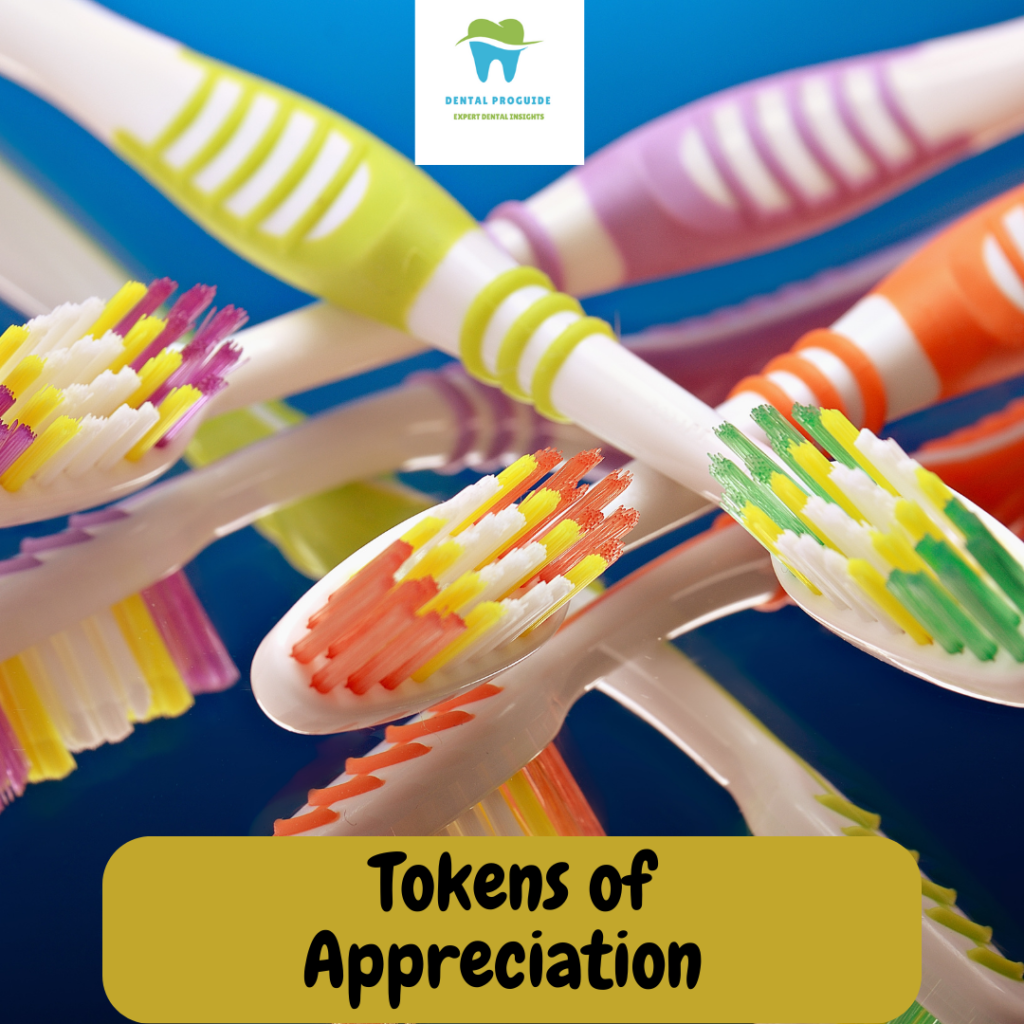 The images shows many colourful toothbrushes and the text " tokens of appreciation" written on a Yellow tab at the bottom.The logo of the website dentalproguide is on the top part.These tokens help in building relationships with patients for a successful dental practice.